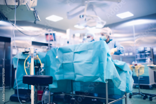 Surgical team during surgery in the operating room, defocused background