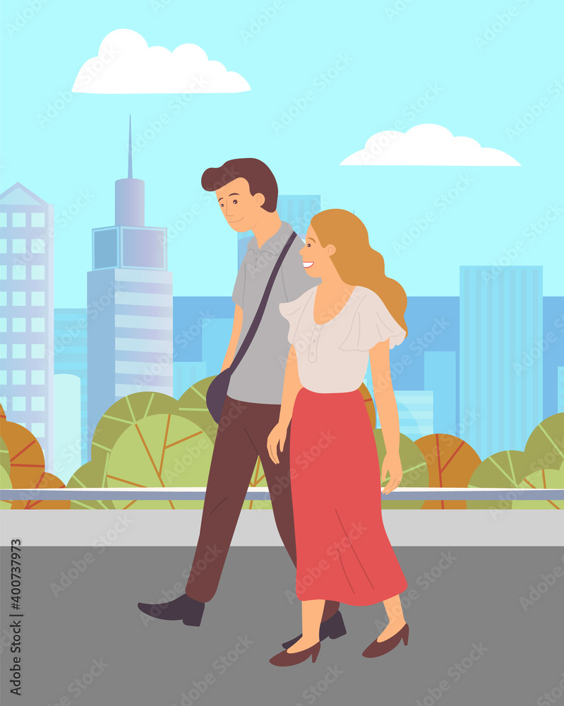 Young couple, long-haired girl and guy in brown trousers, walk in city park. Green square, skyscrapers, buildings background. Happy people hold hands and smile. Outdoor activities, open air walking Young couple, long-haired girl and guy in brown trousers, walk in city park. Green square, skyscrapers, buildings background. Happy people hold hands and smile. Outdoor activities, open air walking