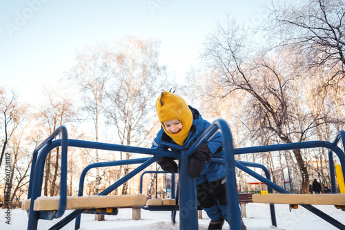 Boy on carousel in winter park. Motion © Татьяна Максимова