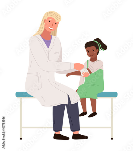 A podiatrist uses a bandage to help a girl. Patient with a sore arm at appointment with doctor. Orthopedist treats small child isolated on white background. Children s doctor works with a patient