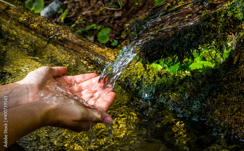 Fotografering Washing Hands And Drink From A Spring With Clear And Cold Mountain Water