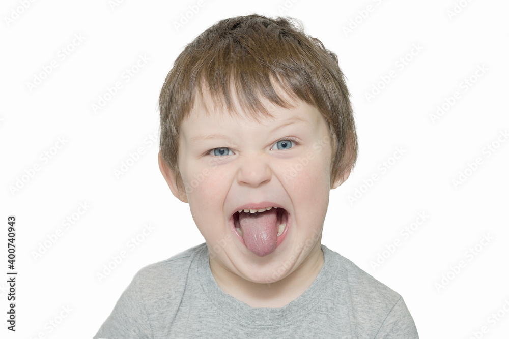 portrait of a boy with his tongue hanging out and a funny expression. The child is fooling around, making faces. horizontal photo isolated on white background. portrait of a boy with his tongue hanging out and a funny expression. The child is fooling around, making faces. horizontal photo isolated on white background.