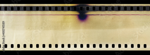 Part of cine 35mm filmstrip, first blank frames on black background, real scan of film material with cool scanning light interferences on the material.