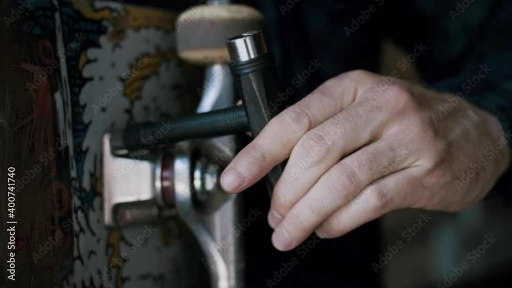 Man working on his skateboard Man working on his skateboard