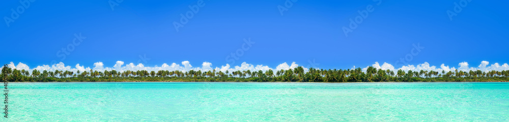 Beautiful view on coconut palms jungle island from sea. Long banner