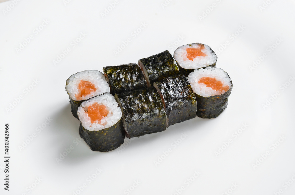Asian cuisine. Sushi maki on a white plate. Top view. On a white background. Asian cuisine. Sushi maki on a white plate. Top view. On a white background.