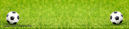 Soccer ball on green grass field with copy space. Long banner © photopixel