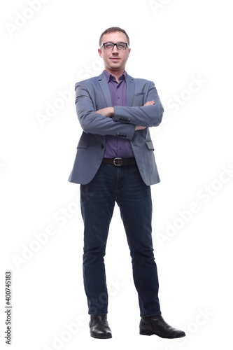Smiling businessman standing with arms folded isolated on a white background