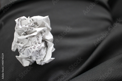 The crumpled bill is placed on gray cloth.