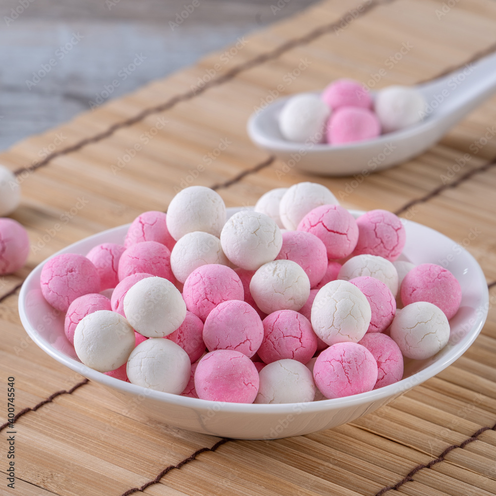 Obraz premium Raw red and white tangyuan on wooden table background for Winter solstice food.