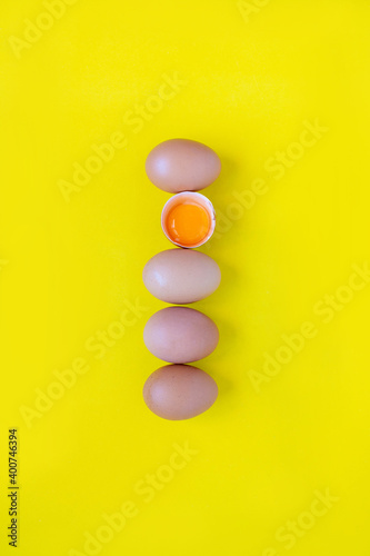 Closeup cracked brown eggs Buy from supermarket Placed side by side on a yellow background