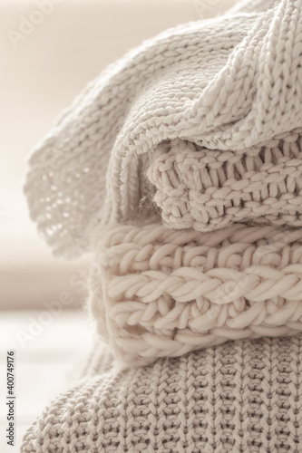 A stack of neatly folded warm knitwear, wool close up.