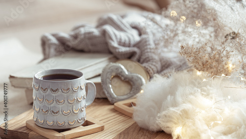 Home composition with beautiful cup on blurred cozy background.