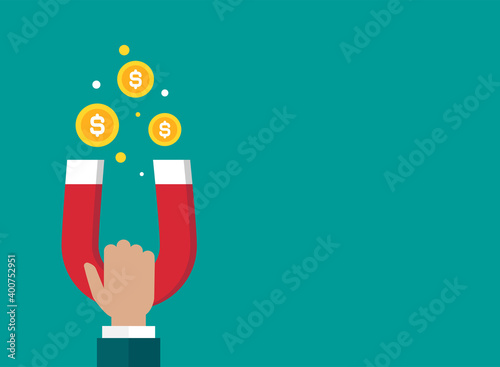 Hand with red horseshoe magnet and dollar coins. Businessman attracting money