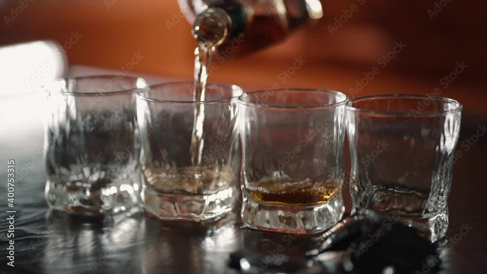Pour alcohol in shot glass. Closeup hand of bartender in bar club make tequila liquor drink. Party Pour alcohol in shot glass. Closeup hand of bartender in bar club make tequila liquor drink. Party