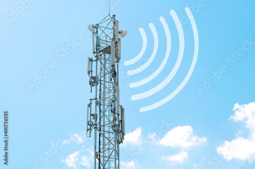 a radio tower with antennas that broadcasts a signal against the background of a blue sky with clouds