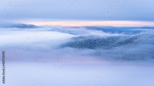Fototapeta Naklejka Na Ścianę i Meble -  Mountain peaks over the clouds. An unigue vista. Bieszczady National Park. Carpathians. Poland.