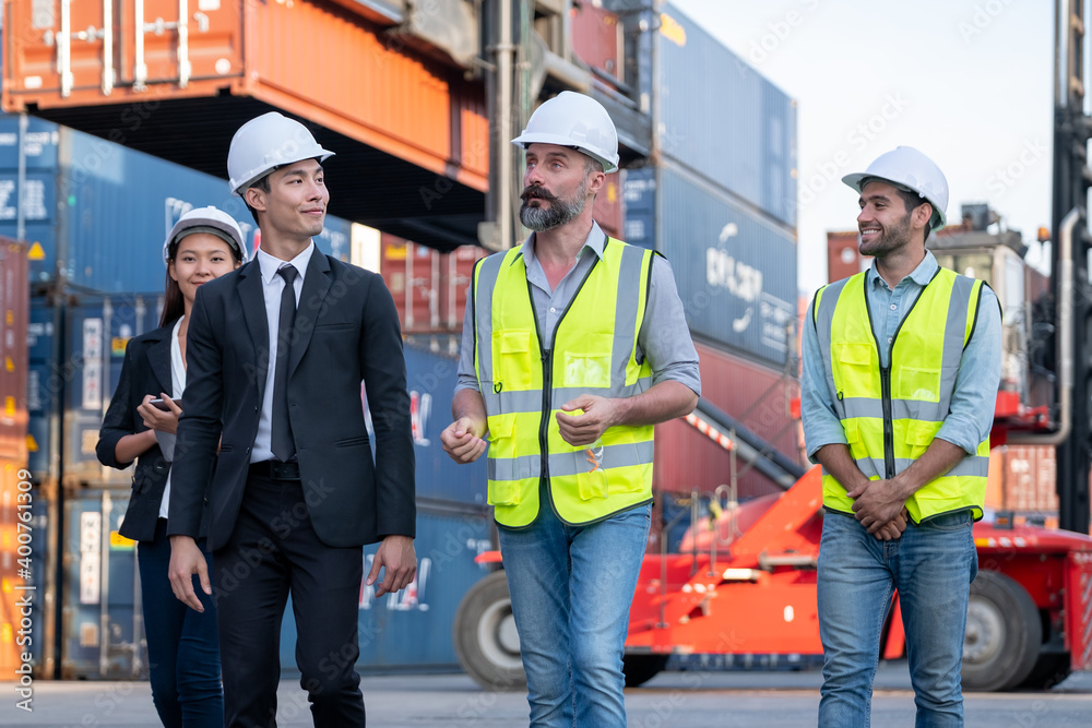 Group of cargo container workers or factory and engineer technicians walk and discuss together in workplace area. Concept of good teamwork support best success work of industrial business. Group of cargo container workers or factory and engineer technicians walk and discuss together in workplace area. Concept of good teamwork support best success work of industrial business.