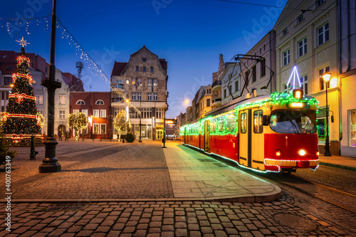 Christmas tram and decorations at the market square in Grudziądz at dusk. Poland