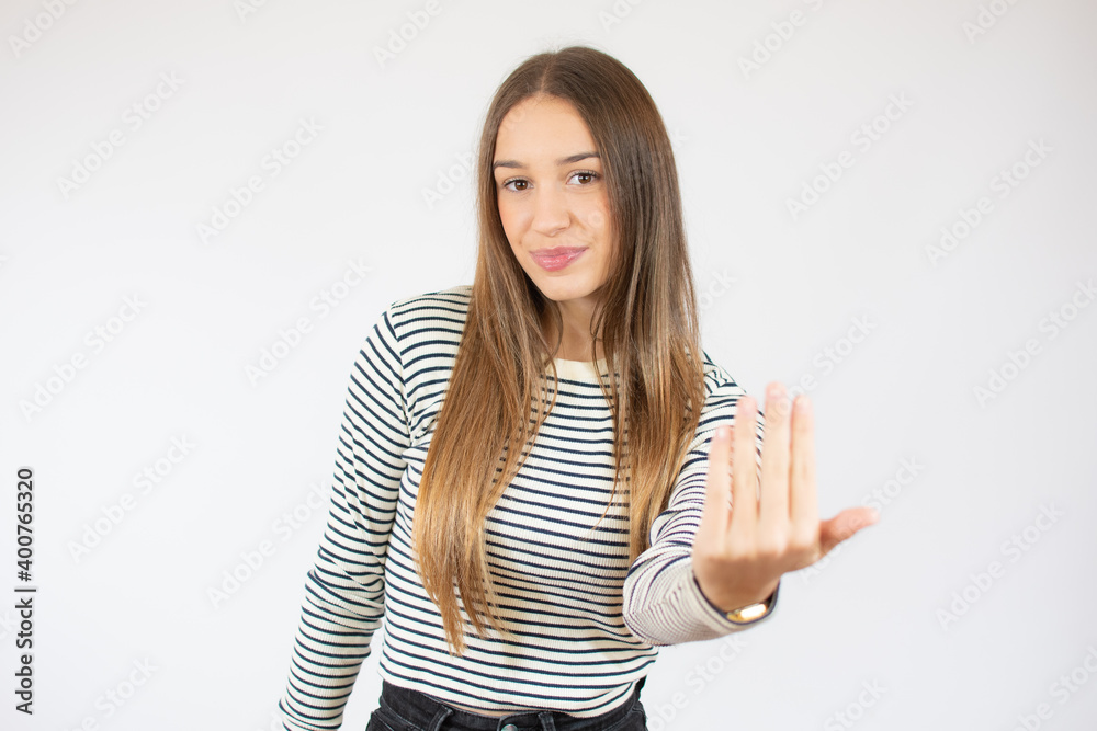 Happy girl in striped t-shirt gesturing beckoning isolated on a white background Happy girl in striped t-shirt gesturing beckoning isolated on a white background