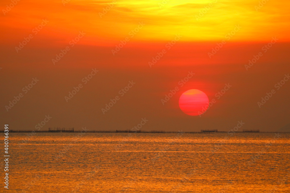 sunset back on the evening dark orange cloud on sky over the sea