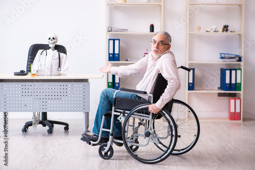 Old man in wheel-chair visiting dead doctor