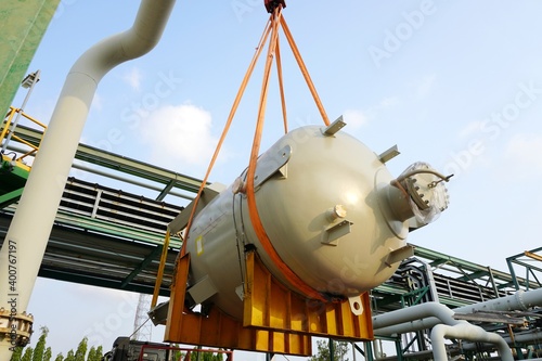 Large chemical tank are being lifted up for installation in the chemical plant construction project.