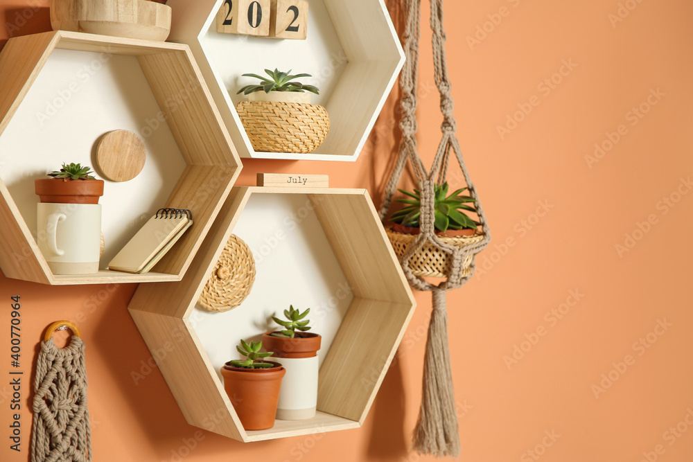 Shelves with decorative elements on color wall. Space for text - obrazy, fototapety, plakaty 