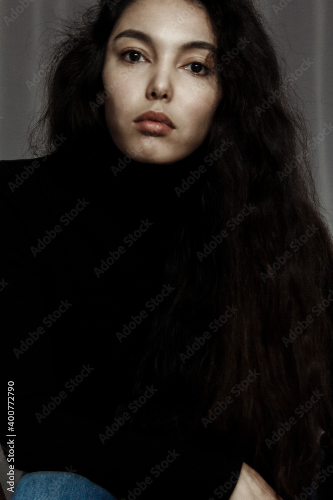 Portrait of beautiful brunette young woman in black looking at camera. Portrait of beautiful brunette young woman in black looking at camera.