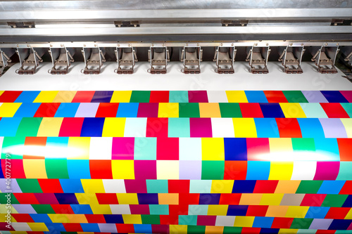 Large format ecosolvent printer at work. Printing color cubes