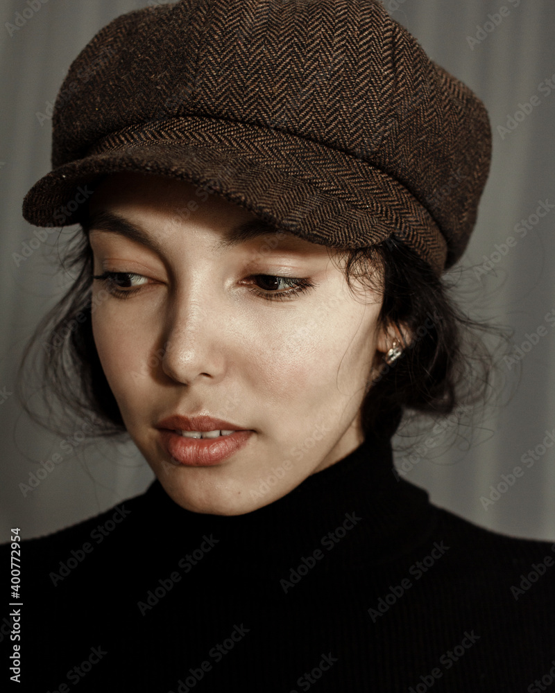 Portrait of beautiful brunette young woman in hat looking at camera. Portrait of beautiful brunette young woman in hat looking at camera.
