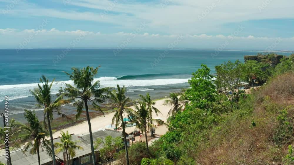 Bingin Beach Bali, is amazing sand beach with scenery mountain cliff in sea, traditional bamboo hotels. Pantai Bingin surfer paradise for active lifestyle travel tourist. 4K Aerial view Bingin Beach Bali, is amazing sand beach with scenery mountain cliff in sea, traditional bamboo hotels. Pantai Bingin surfer paradise for active lifestyle travel tourist. 4K Aerial view