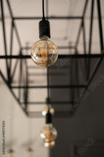 Hanging lamps on the background of metal structure in a loft