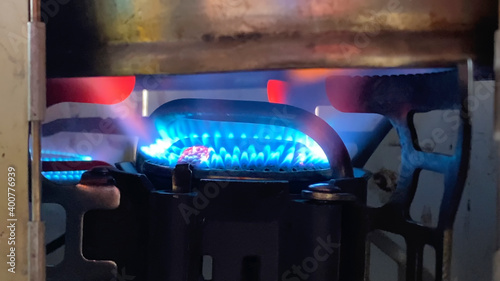 Fototapeta Naklejka Na Ścianę i Meble -  Travel gas burner. Blue flame from a gas burner close-up.