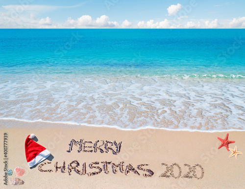 Merry Christmas 2020 written on the sand