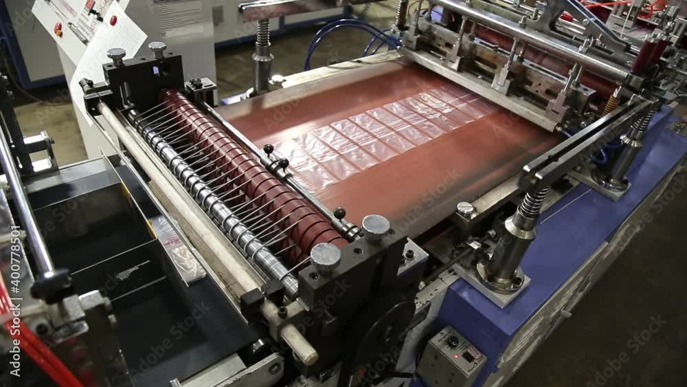 Manufacturing and Automated Technology Concept. Production of Plastic Bags and Polyethylene Zipper. Work Automatic Machine. Recycling, Industry. Top view. High quality FullHD footage Manufacturing and Automated Technology Concept. Production of Plastic Bags and Polyethylene Zipper. Work Automatic Machine. Recycling, Industry. Top view. High quality FullHD footage