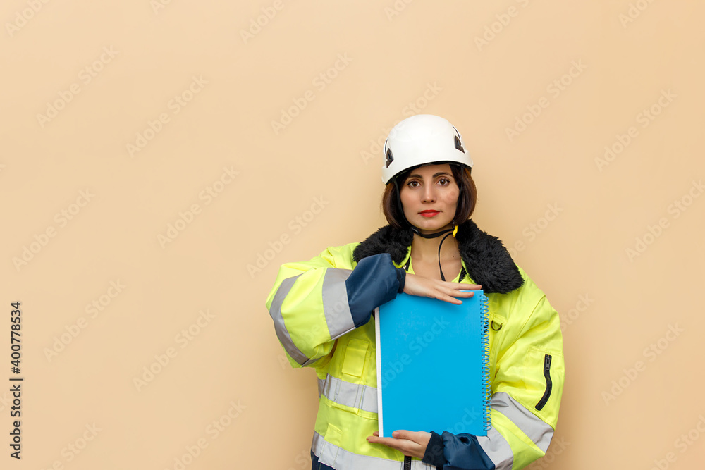 Female industrial worker in hard hat with document folder. Woman engineer with white hard hat. Climber Female industrial worker in hard hat with document folder. Woman engineer with white hard hat. Climber