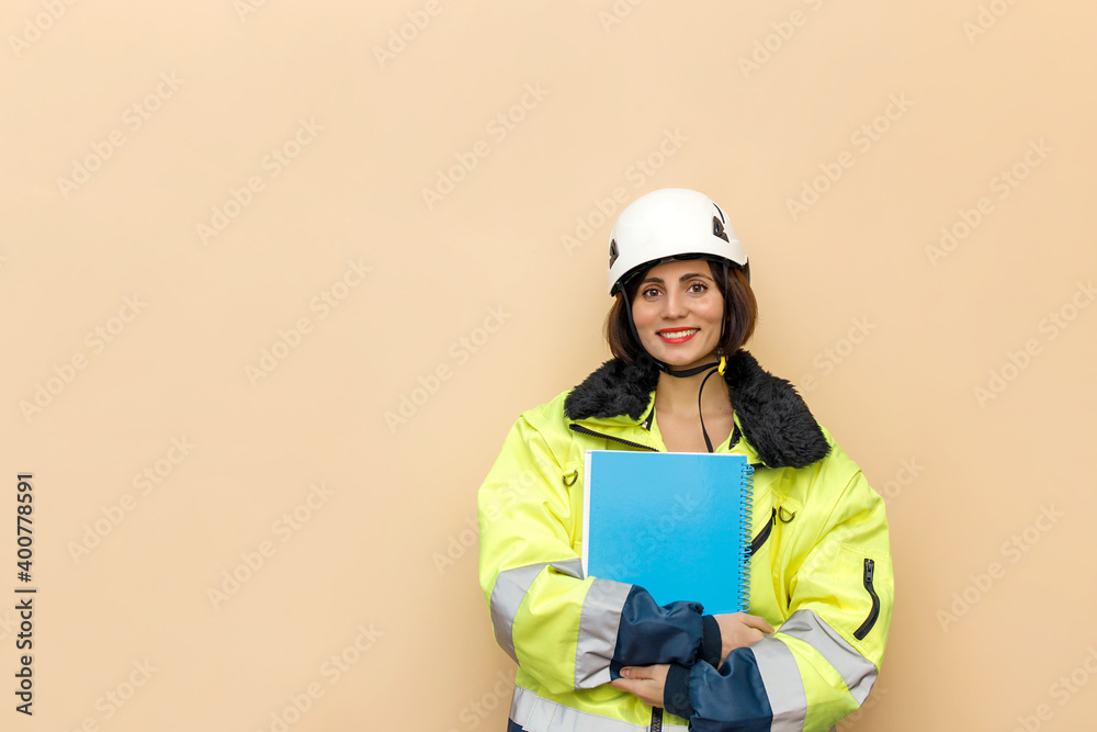 Female industrial worker in hard hat with document folder. Woman engineer with white hard hat. Climber Female industrial worker in hard hat with document folder. Woman engineer with white hard hat. Climber