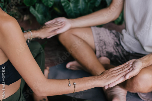 White hippie couple doing healthy meditation yoga and relationship body practice during sunset time in the nature