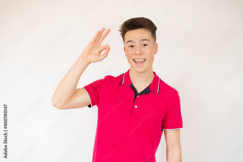 Portrait of a cheerful young boy showing okay gesture isolated over white background Portrait of a cheerful young boy showing okay gesture isolated over white background