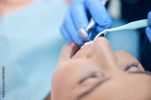 Young pretty female being treated in dental clinic