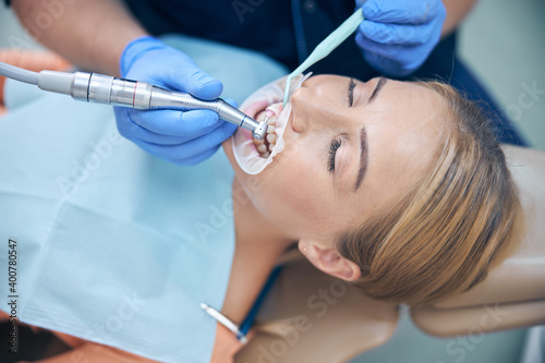 Young woman during dental procedure in clinic