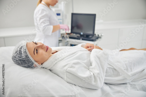 Smiling female patient dressed in a bathrobe