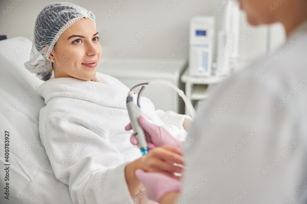Doctor conducting a skin rejuvenation treatment on female hands Doctor conducting a skin rejuvenation treatment on female hands