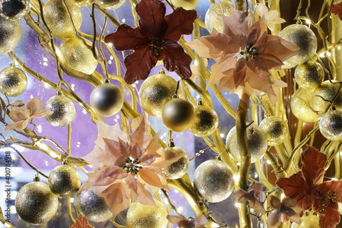 New Year's festive decorations of manors in yellow shades on a purple background. Christmas decorations. Festive room design. Artistic work. Fun mood. The atmosphere of a fairy tale and mystery