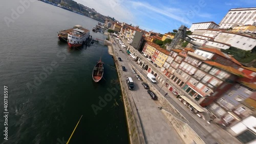 Fly over boats and riverside FPV drone Dom Luis bridge Porto Portugal photo