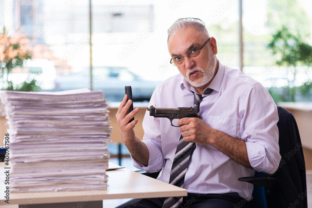 Aged businessman employee unhappy with excessive work Aged businessman employee unhappy with excessive work