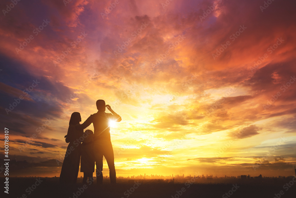 Silhouette of happy family look at modern city