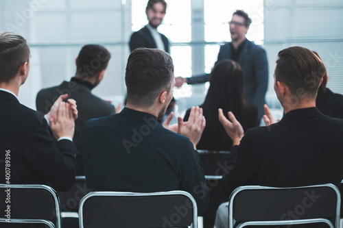 working group applauding business partners during the meeting