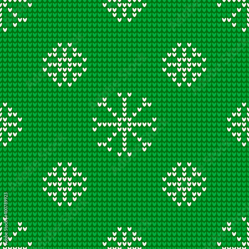 Seamless knitting pattern with snowflakes is on the green background. Save with the Clipping Mask.